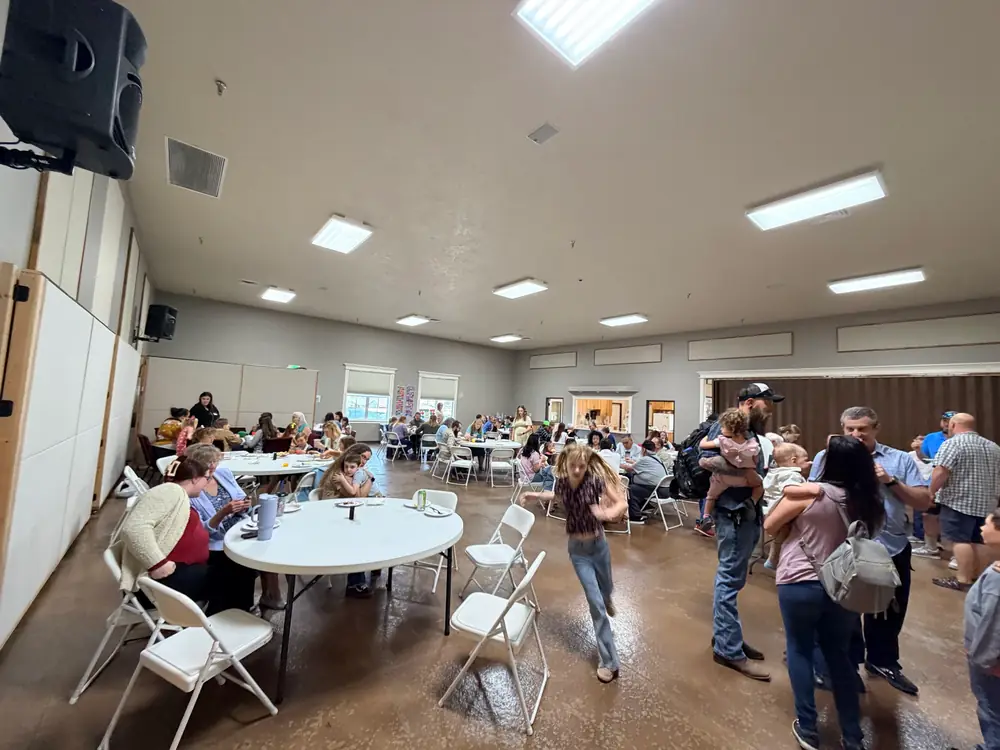 Crosspoint Church family greeting one another in the fellowship hall in Caldwell, Idaho