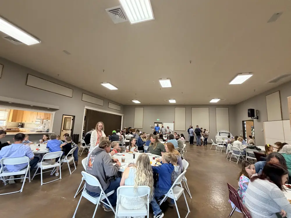 Church members sharing a meal around tables at Crosspoint Church of Caldwell